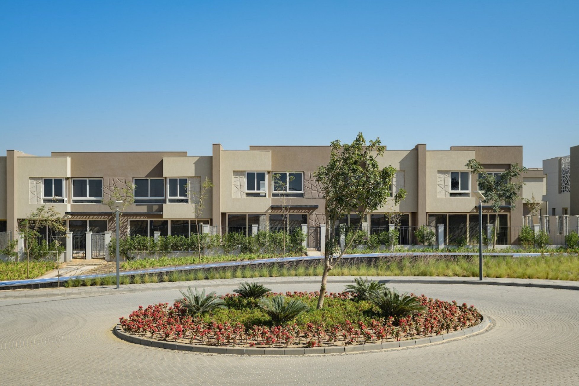 Central roundabout — A landscaped traffic island at the heart of a townhouse neighbourhood.