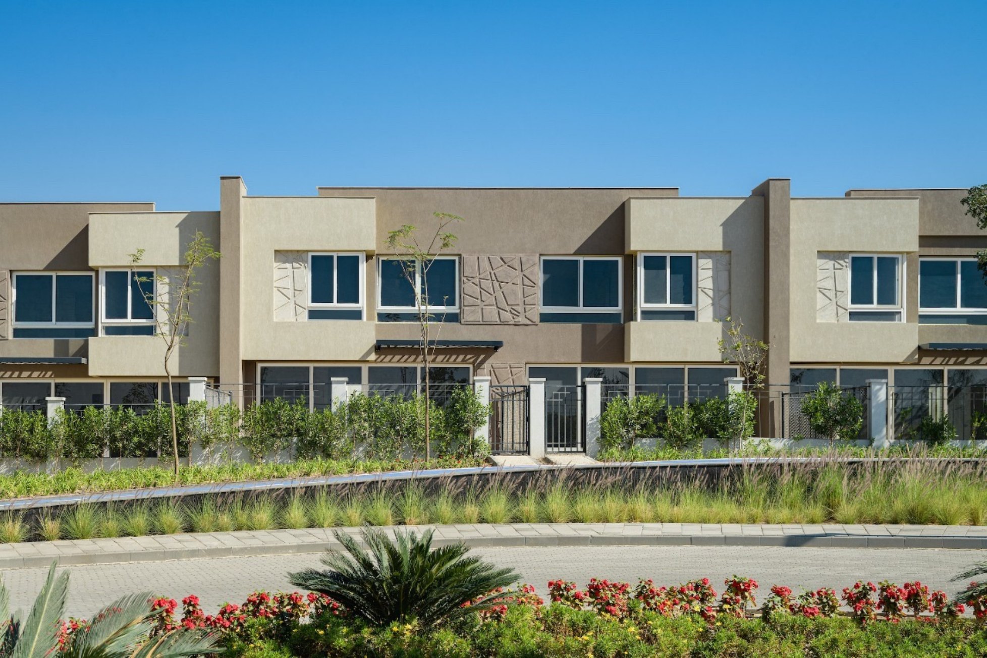 Townhouse row — A row of modern townhouses with landscaped front gardens.