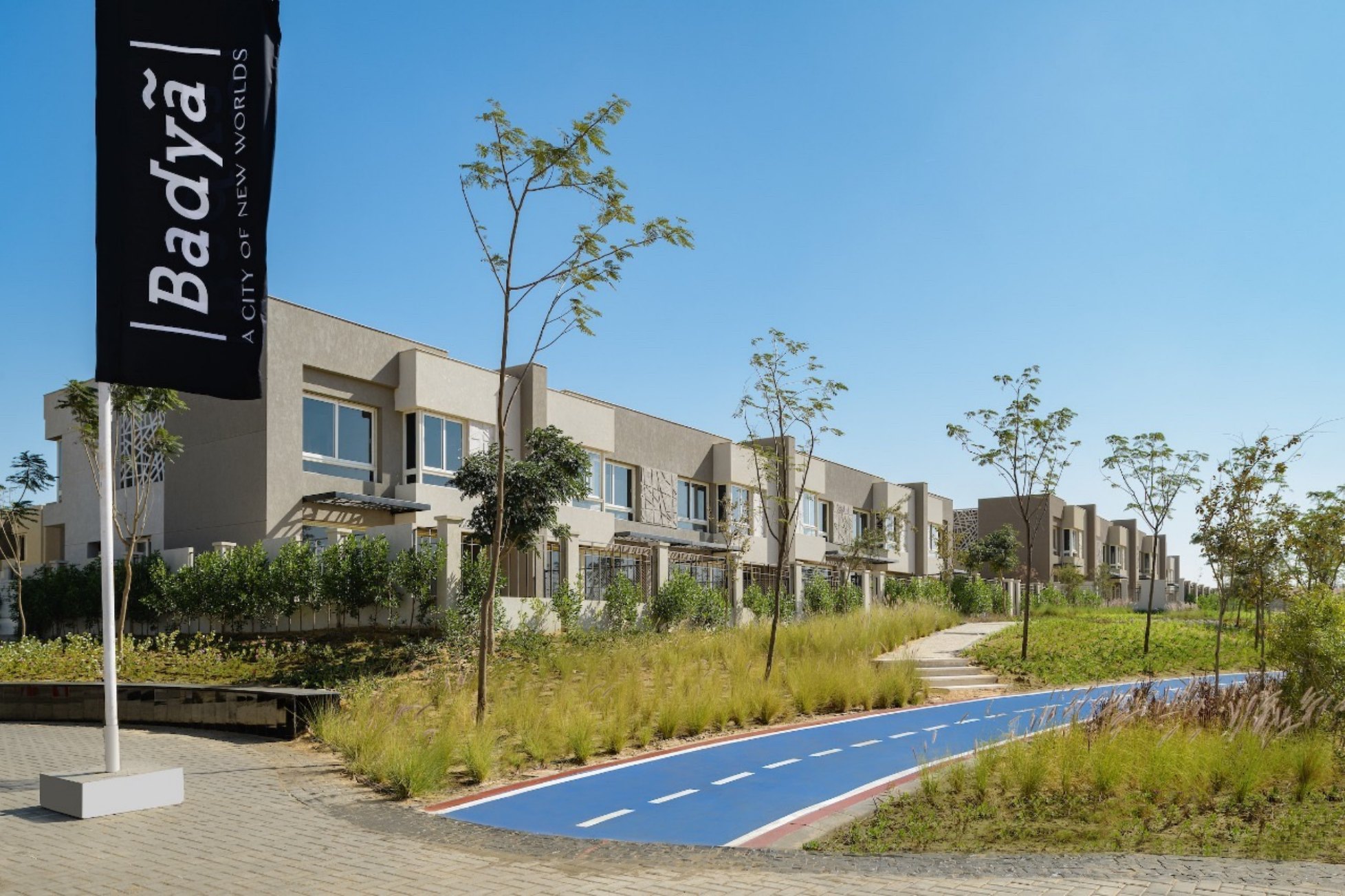 Pathway along villas — A landscaped pathway with Badya signage in front of a villa row.