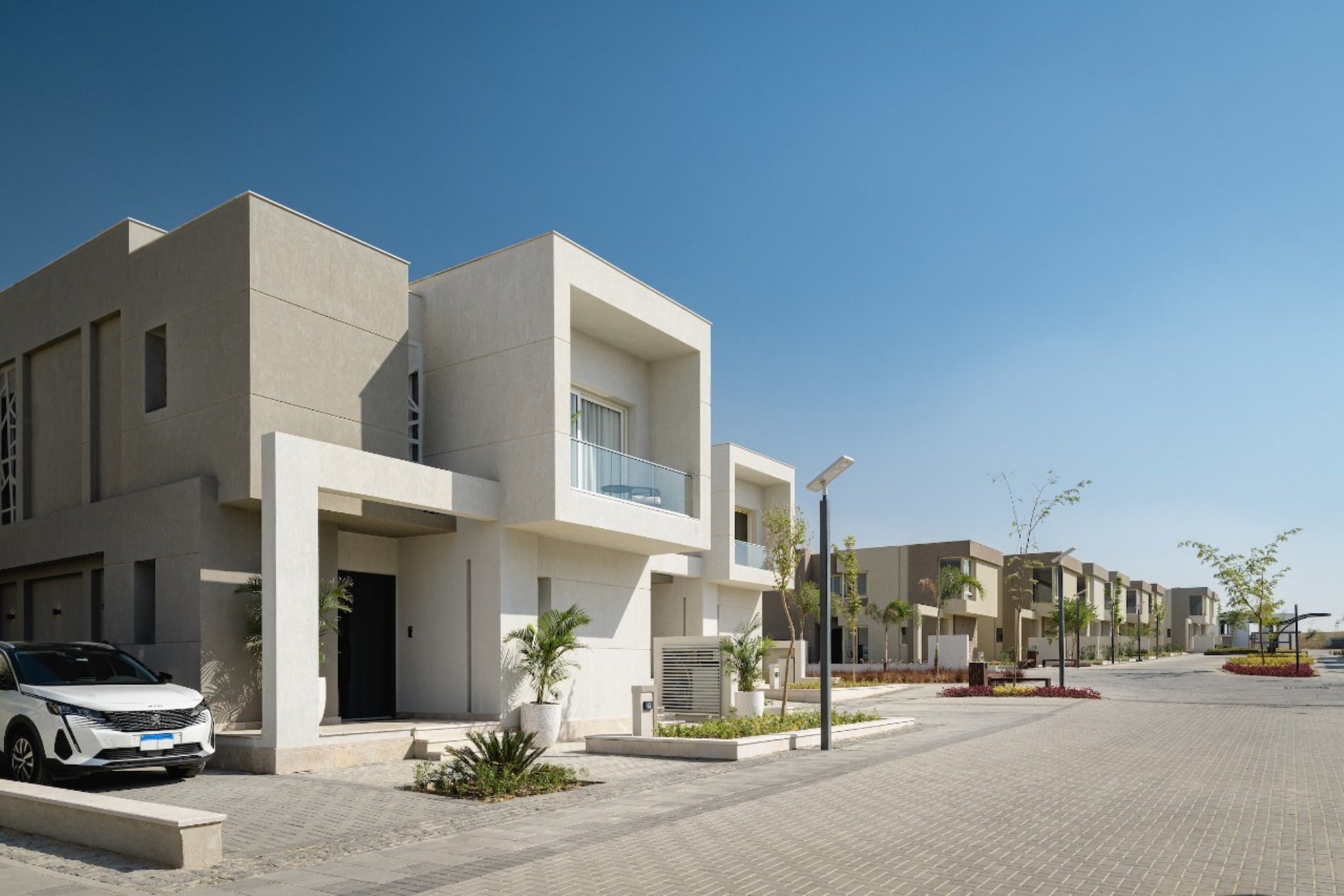 Neighbourhood street — Homes and driveways along a quiet residential street.