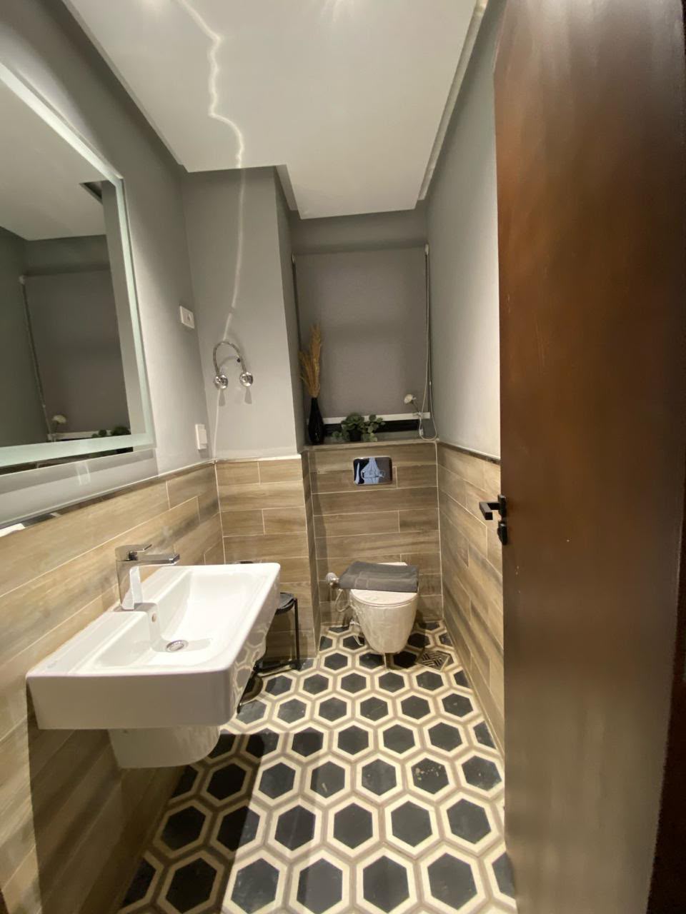 Powder room — Powder room with patterned floor tiles.