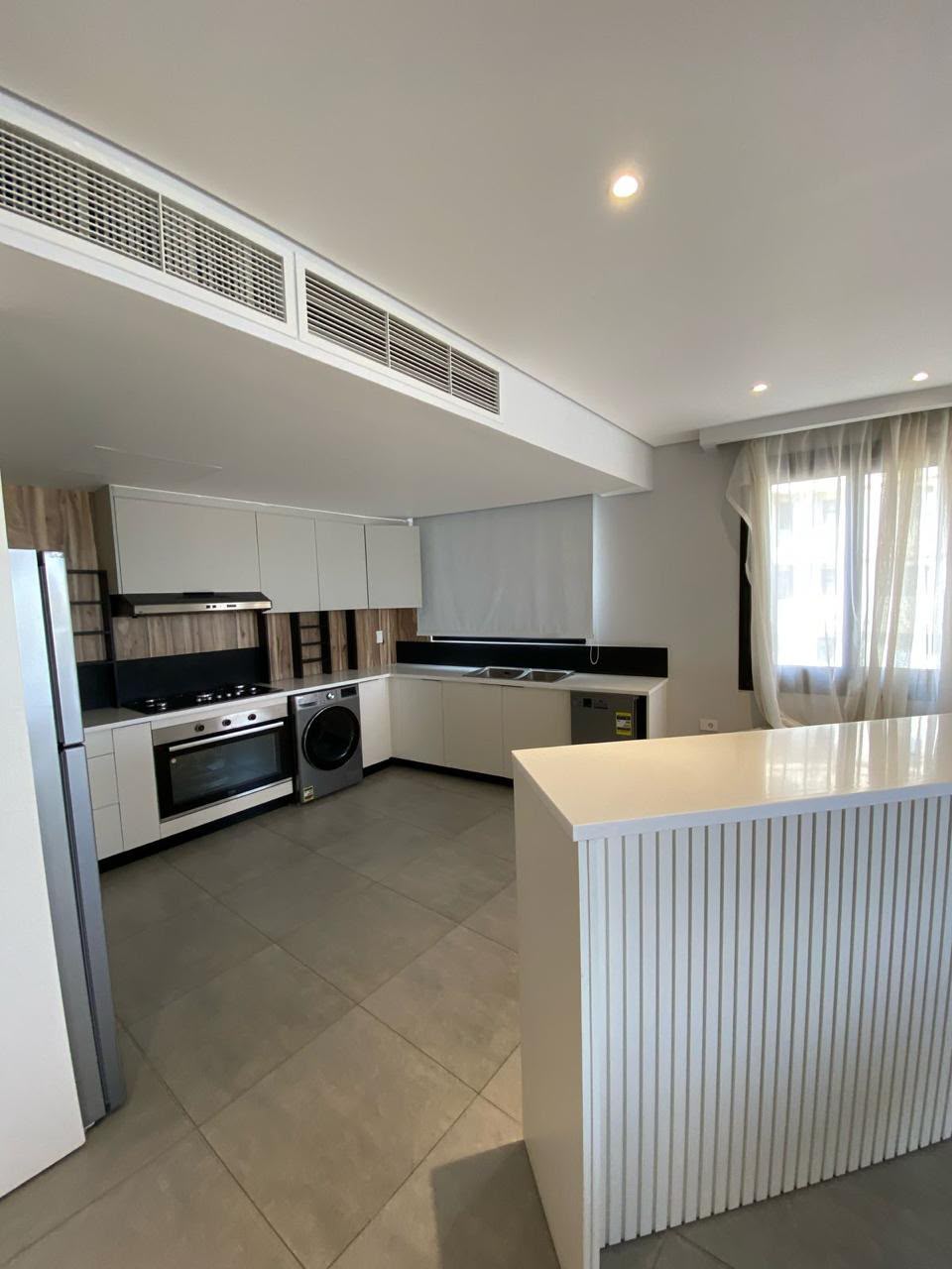 Fitted kitchen — Kitchen with integrated appliances and a breakfast bar.